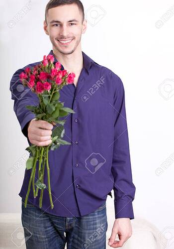 17537133-young-man-giving-flowers-at-camera-over-white